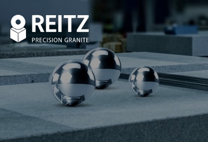 Three shiny steel balls on finely machined precision granite
